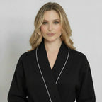 Black knee-length waffle robe for women with piping, plush fabric, from Plush Fashion Hub, front view showing relaxed fit and cozy design.