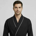 Front view of Plush Fashion Hub men's premium waffle piping robe in small black, showcasing cozy fabric and piping details.