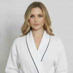 Women’s knee-length waffle robe by Plush Fashion Hub in small white with piping, front view showing soft textured fabric and piping details.