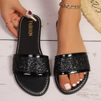Women's glitter open toe flat sandals from Trendsi, stylish summer footwear with sparkling details and comfortable flat sole.