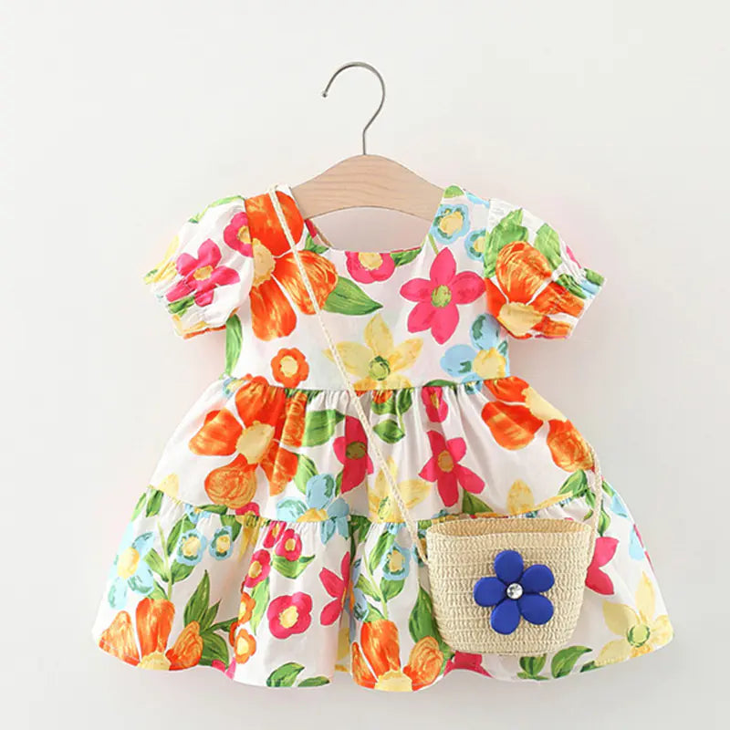 Girls' floral dress with matching bag from Trendy Attic Store01, featuring bright, colorful flower patterns and a comfortable fit.