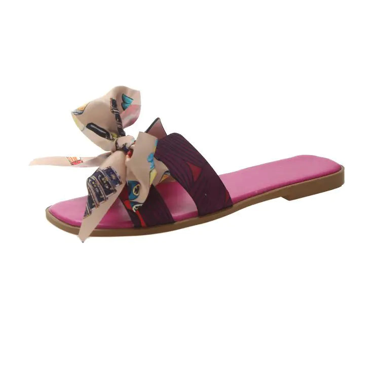 Women's summer flat slippers with bow detail, trendy women's sandals from Trendy Attic Store01, comfortable and stylish for warm weather.