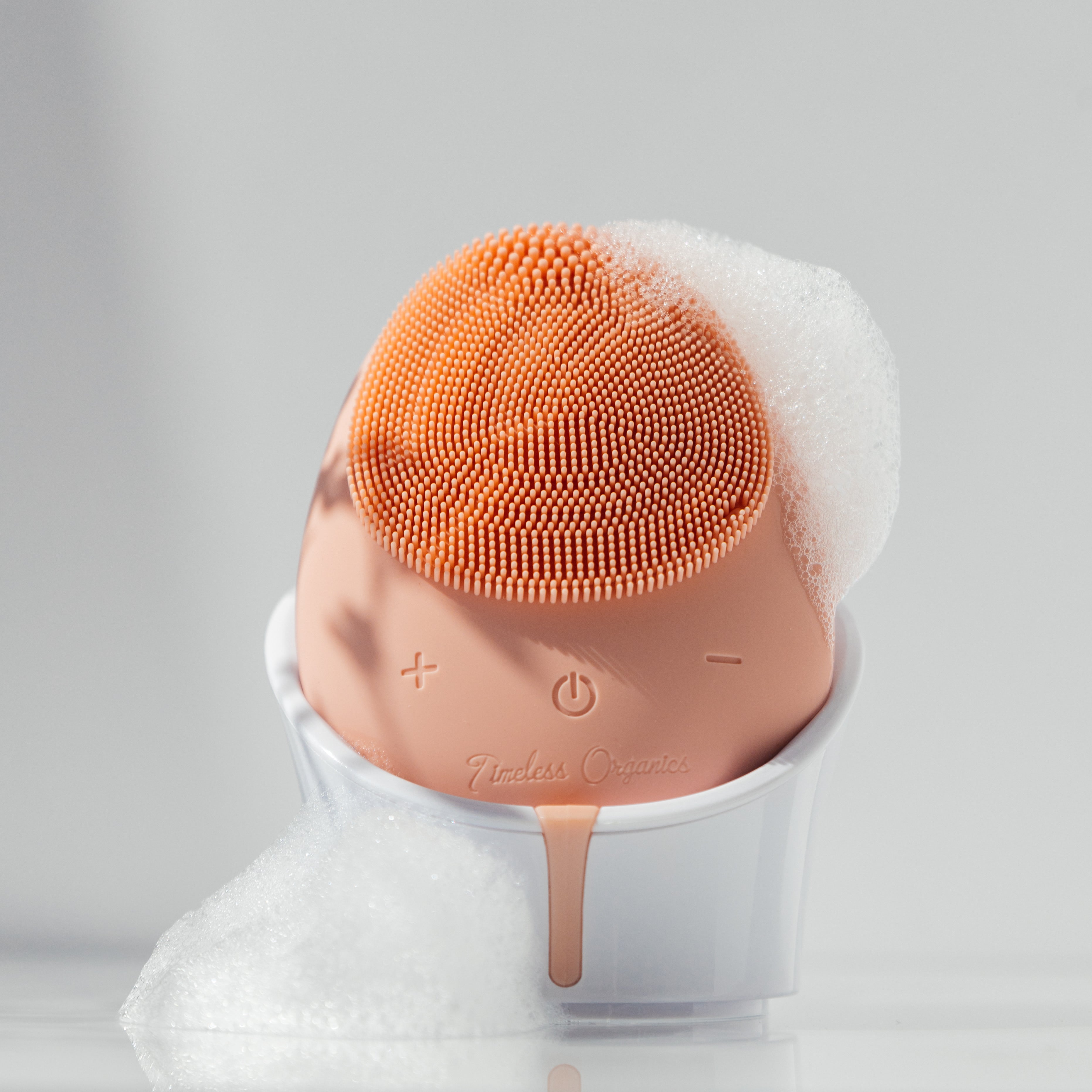Timeless Organics Skin Care facial cleansing brush device with soft bristles for gentle, effective skincare.