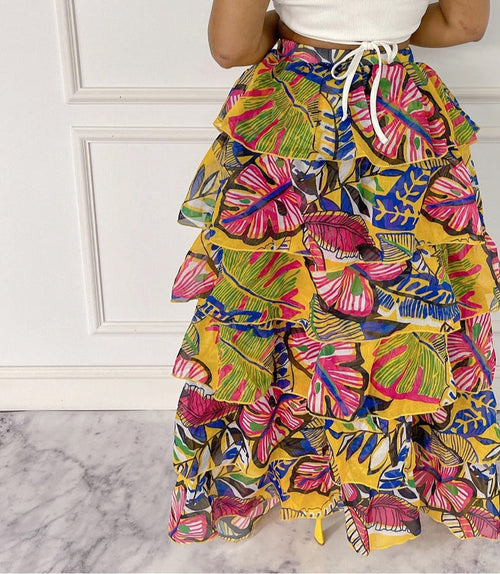 Fasheabe Blissful Views printed ruffled high-low skirt with floral pattern and layered ruffles, styled for a flowy, elegant look.