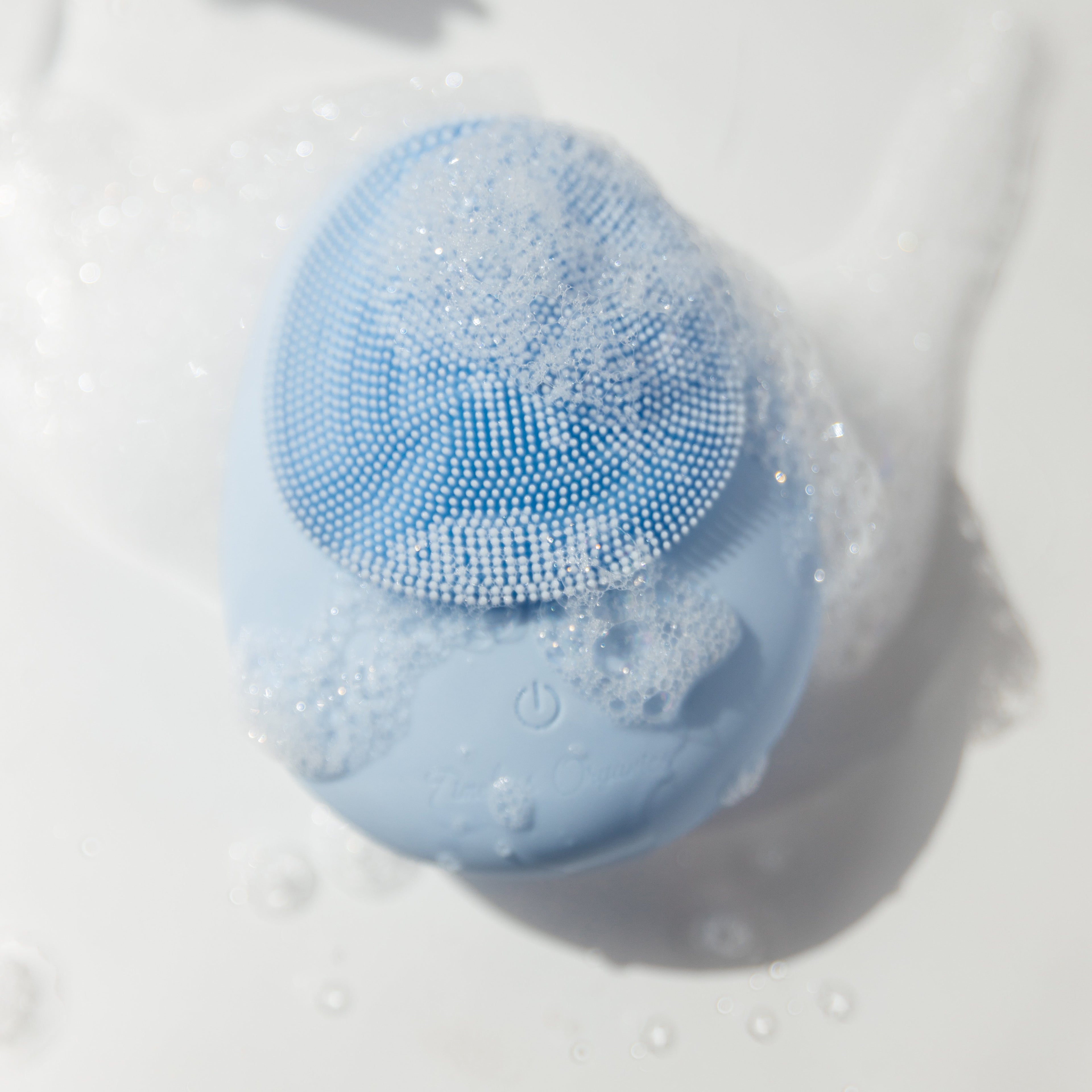 Timeless Organics Skin Care facial cleansing brush device with soft bristles for gentle skin cleansing and exfoliation.