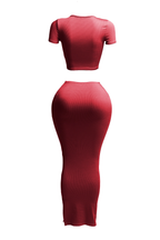 Two-piece crop top and long skirt set by The House of Stylez, featuring a stylish short sleeve crop top and flowing skirt.