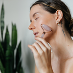 Rose quartz facial roller device from Timeless Organics Skin Care, showing the smooth, pink stone roller used for facial massage.