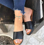 Comfortable women's wedge heel sandals with mid-height heel, featuring stylish straps and a neutral color for versatile wear.