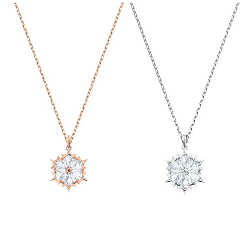 Silver snowflake necklace with diamond pendant, showcasing intricate design and sparkling gemstones, from Plush Fashion Hub.