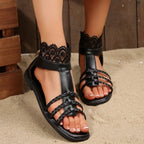 Women's lace open toe flat sandals made of PU leather, featuring intricate lace details and summer-ready design.