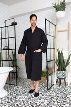 Men's plush waffle spa bathrobe from Plush Fashion Hub, lightweight and absorbent, shown hanging with a shawl collar and tie waist.