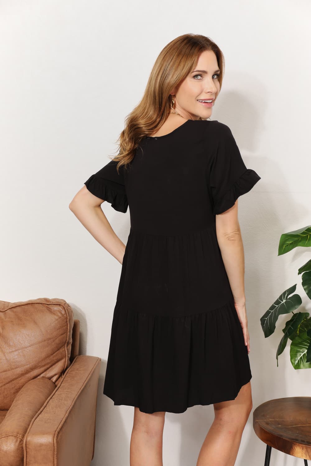 Mandy Women's solid V-neck casual dress with tiered design and flounce sleeves, stylish women’s apparel by Trendsi.