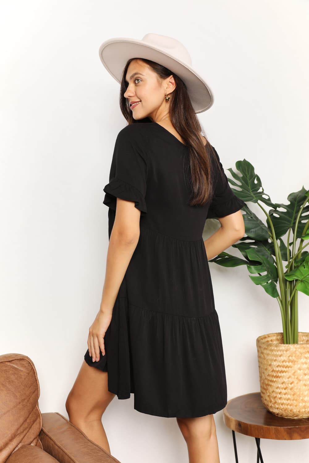 Mandy Women's solid V-neck tiered dress with flounce sleeves, casual style, in a lightweight fabric, worn by a model.