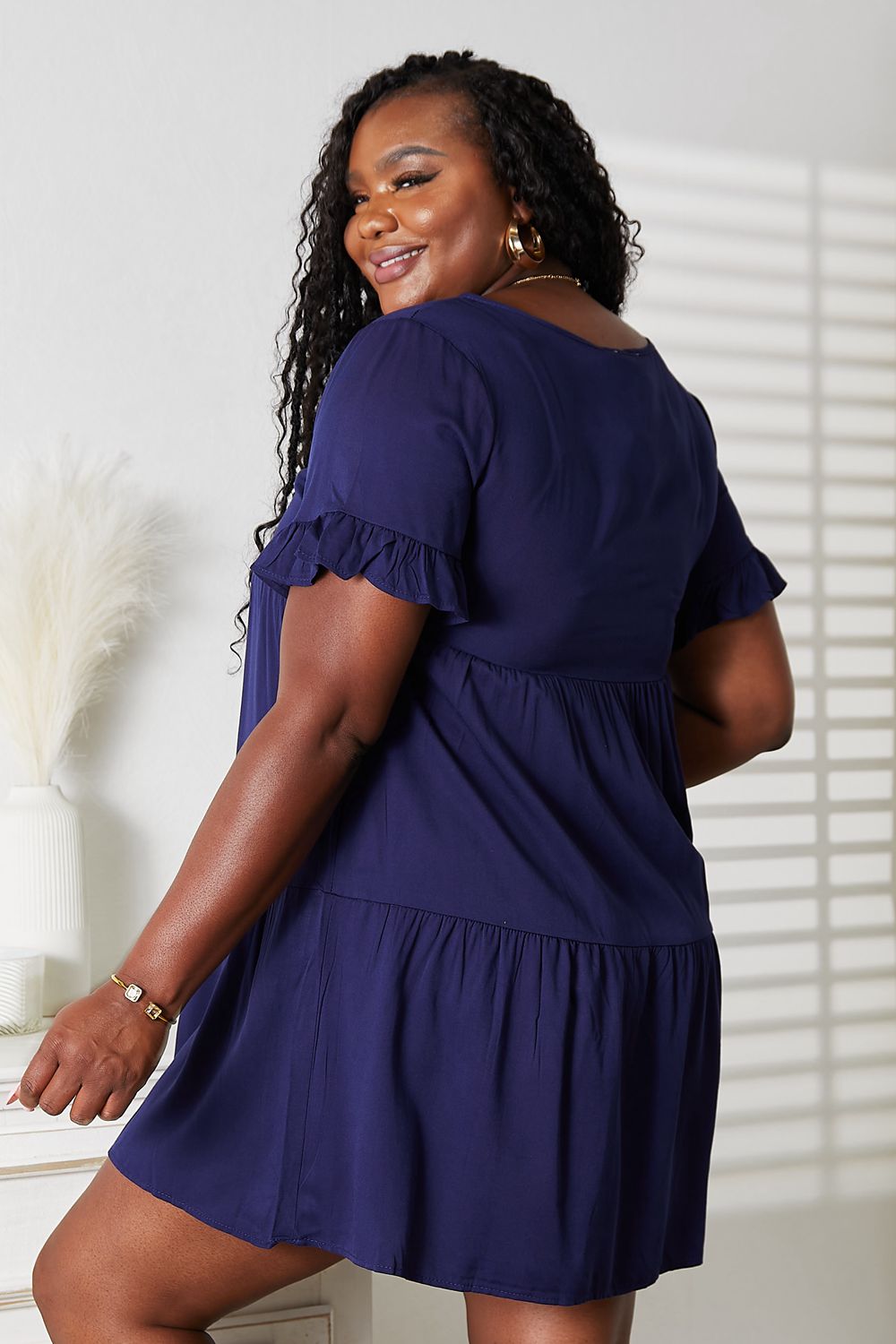 Mandy women's solid V-neck tiered casual dress with flounce sleeves, featuring a relaxed, stylish fit for everyday wear.