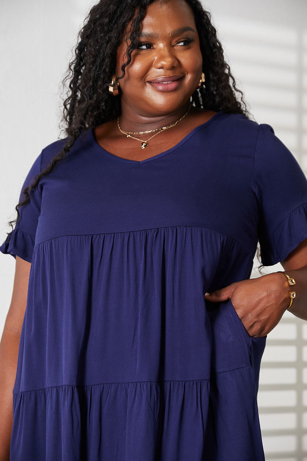 Mandy Women's solid V-neck casual dress with tiered design and flounce sleeves, stylish women’s apparel from Trendsi.