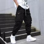 Men's multi-pocket drawstring cargo pants in streetwear style by Plush Fashion Hub, featuring multiple pockets and a relaxed fit.