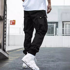 Men's multi-pocket drawstring cargo pants in streetwear style by Plush Fashion Hub, featuring multiple pockets and a relaxed fit.
