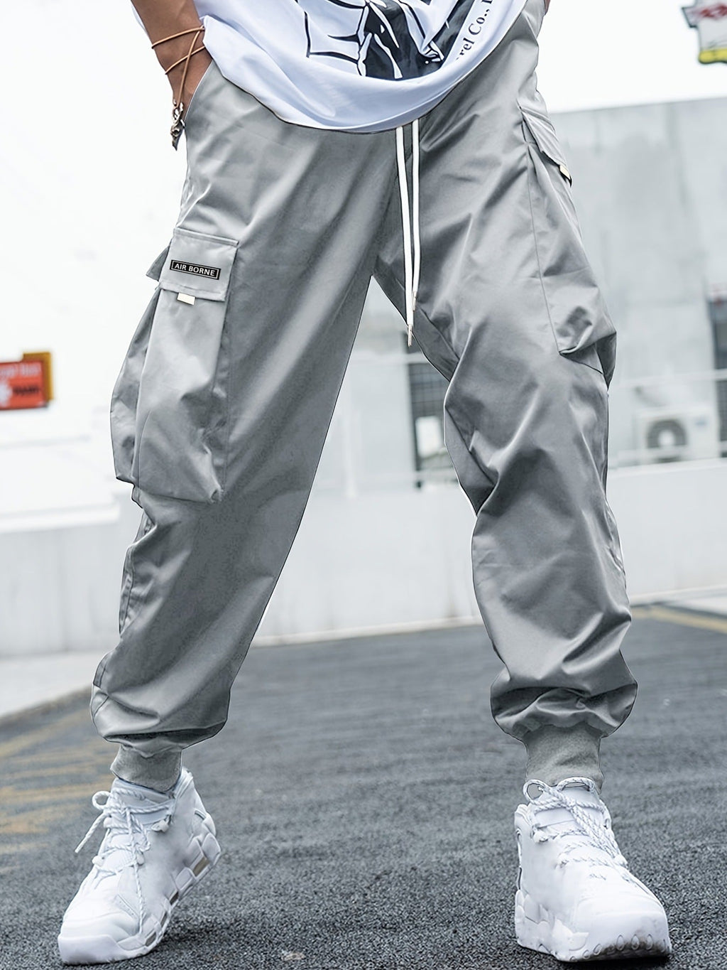 Men’s multi-pocket drawstring cargo pants from Plush Fashion Hub, featuring streetwear style with functional pockets and adjustable waistband.