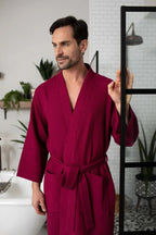 Red men's waffle spa bathrobe from Plush Fashion Hub, lightweight and absorbent, ideal for relaxing after a bath or shower.