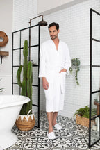 Men's waffle spa bathrobe from Plush Fashion Hub, lightweight and absorbent, shown hanging with a relaxed fit and soft texture.