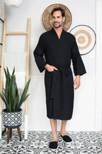 Men's waffle spa bathrobe by Plush Fashion Hub, lightweight and absorbent, shown draped over a man in a bathroom setting.