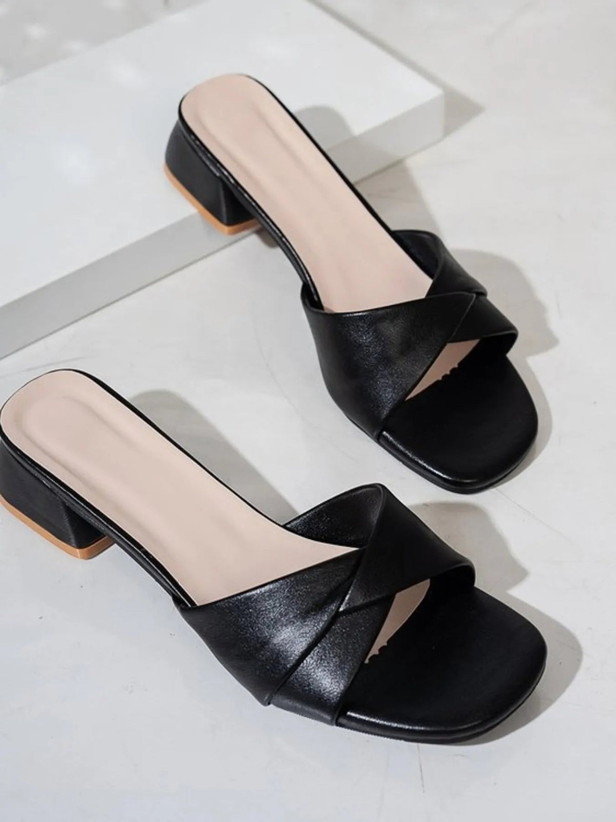 Women's open toe block heel sandals in faux leather featuring a stylish design and comfortable chunky heel.