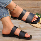 Women's open-toe vegan leather flat sandals with stylish straps, designed for comfortable everyday wear.
