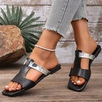 Women's open-toe vegan leather flat sandals with a chic design, featuring a comfortable footbed and stylish straps.