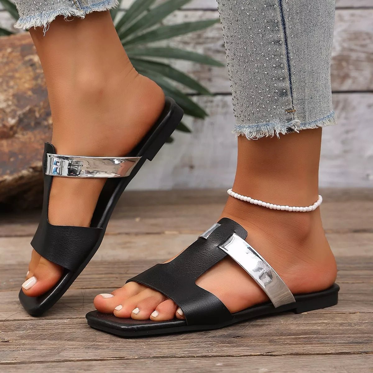 Women's open-toe vegan leather flat sandals with straps, stylish and comfortable for everyday wear.