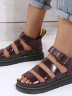 Women's open toe platform sandals in chic faux leather with a trendy slide design, perfect for stylish warm-weather wear.