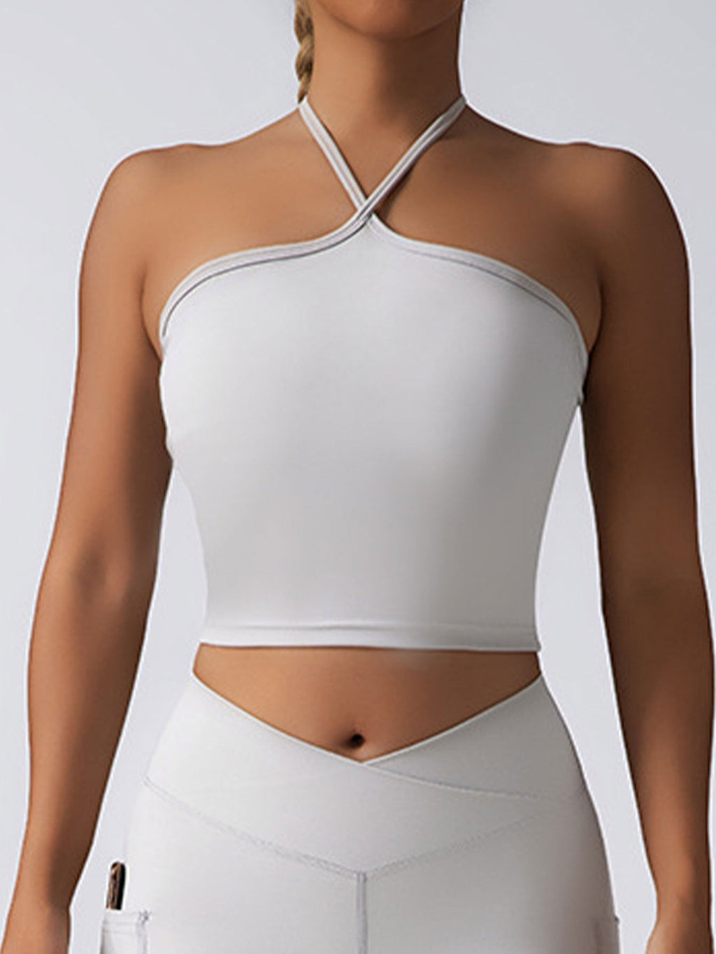 Seamless plush pink padded crop top push-up sports bra, supportive gym tank for women with athletic fit and breathable fabric.