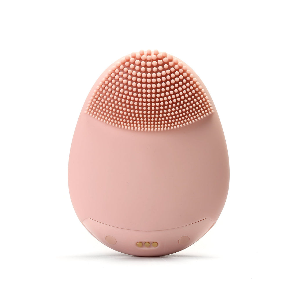 Pale pink Timeless Facial Cleansing Brush device from Timeless Organics Skin Care with soft bristles for gentle facial cleansing.