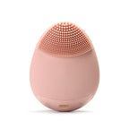 Pale pink Timeless Facial Cleansing Brush device from Timeless Organics Skin Care with soft bristles for gentle facial cleansing.
