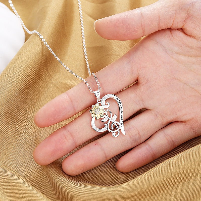 Pastoral-style two-color sunflower pendant necklace with heart-shaped chain, featuring a trendy design from Plush Fashion Hub.