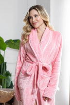 Pink women's plush bathrobe with ultra-soft fleece fabric from Plush Fashion Hub, displayed hanging on a hook.