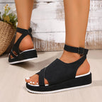 Women's platform ankle strap comfort sandals in faux leather featuring a casual design and ankle buckle detail.