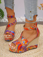 Women's faux leather platform wedge sandals with ankle strap from Trendsi, featuring a stylish design and comfortable heel height.