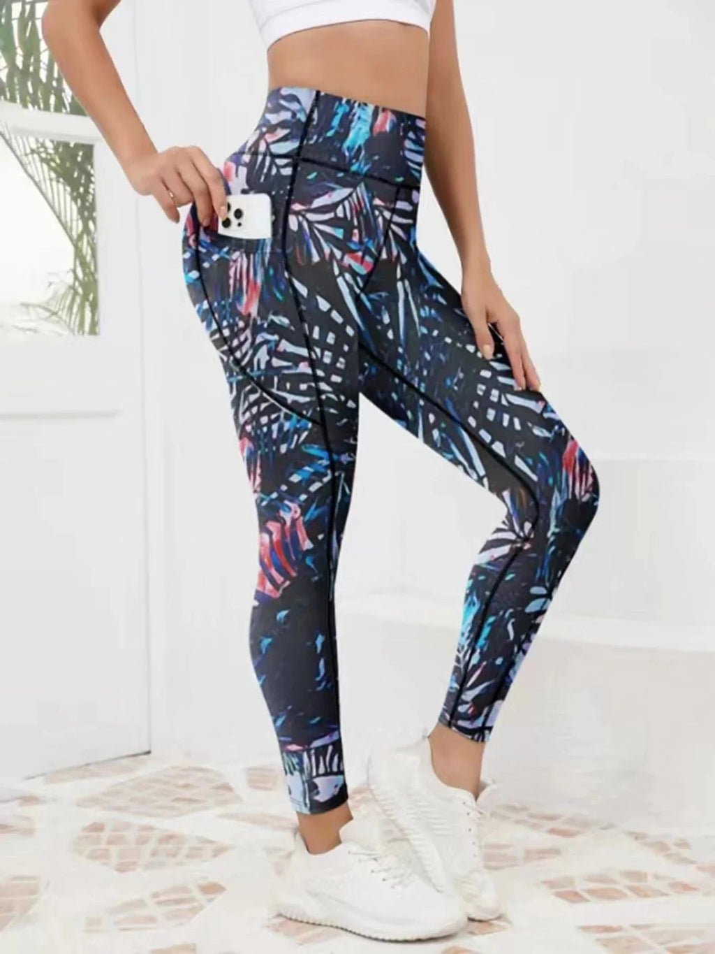 Women wearing FitiqueFit printed high-waist pocket fitness leggings with colorful abstract pattern for activewear.