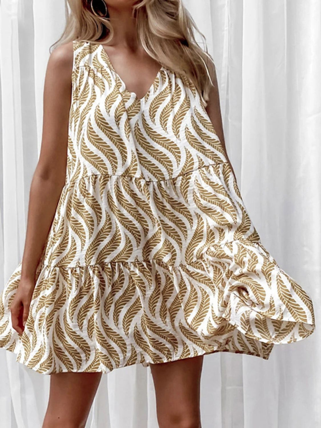 Women's printed V-neck sleeveless A-line summer mini dress from Trendsi, featuring vibrant floral pattern and lightweight fabric.