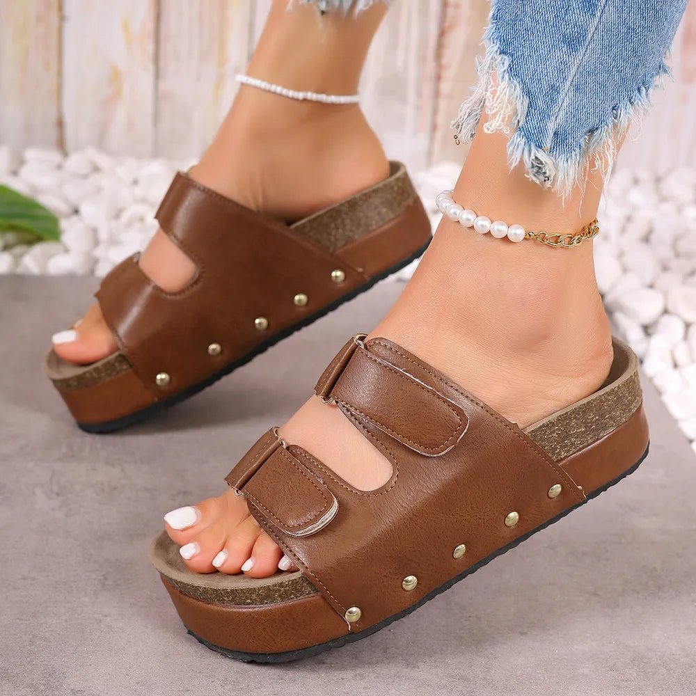 Women's studded PU leather platform sandals with edgy design and comfortable fit, featuring ankle straps and chunky soles.