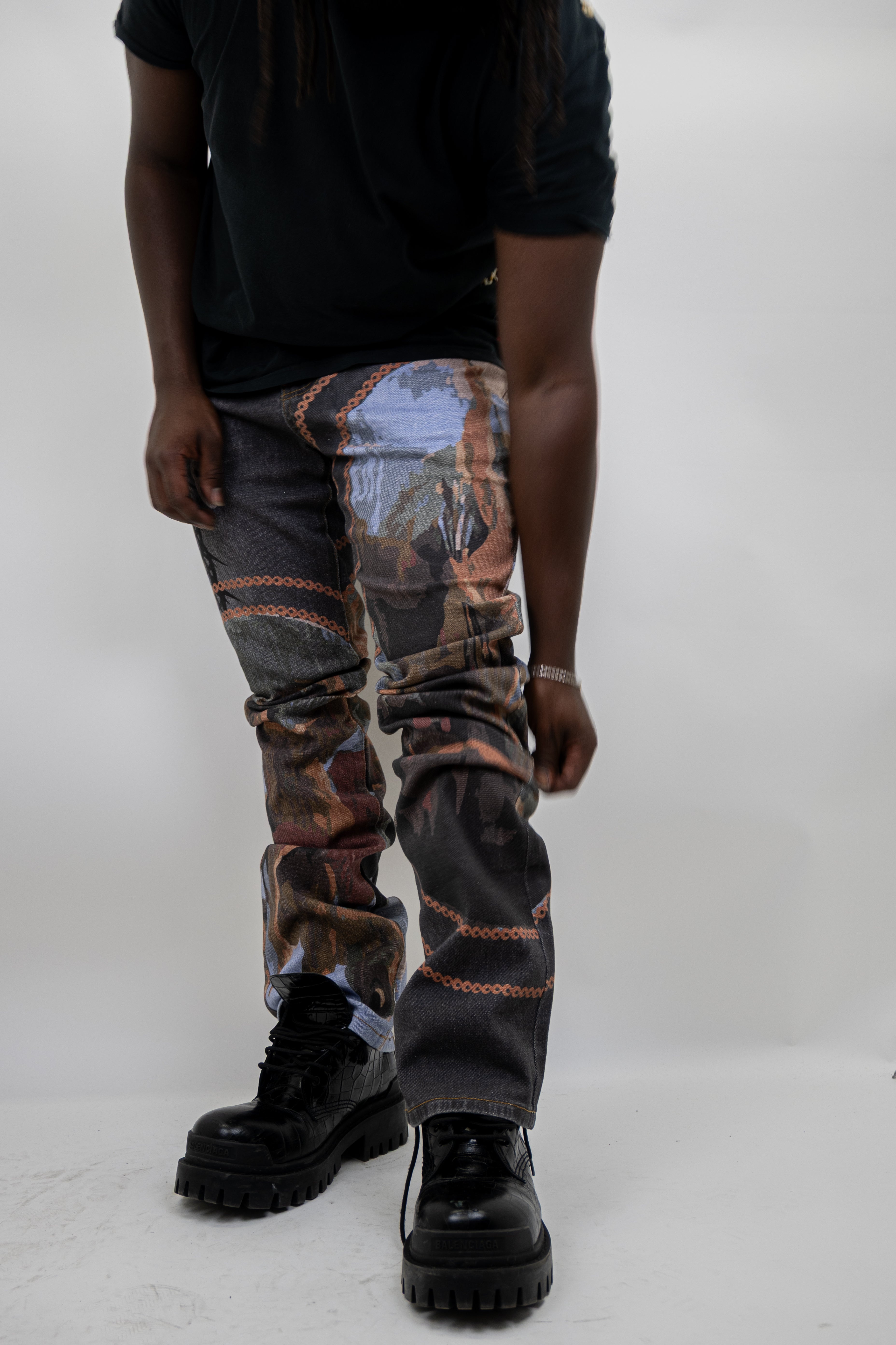 Purple ARMOR JEANS RM202SK graphic printed stacked jeans with bold design and tapered fit, shown on a model in the image.