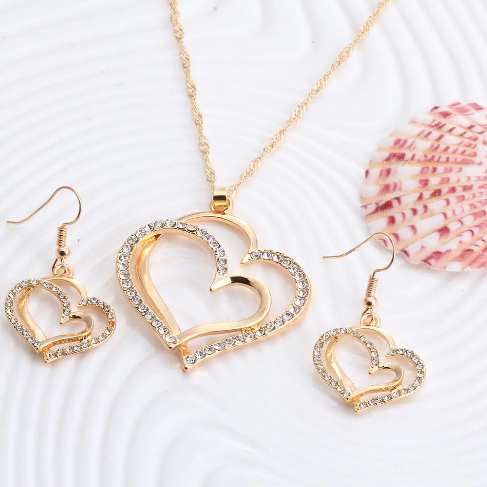 Double heart wedding jewelry set with matching necklace and earrings from Plush Fashion Hub, featuring elegant heart-shaped designs.