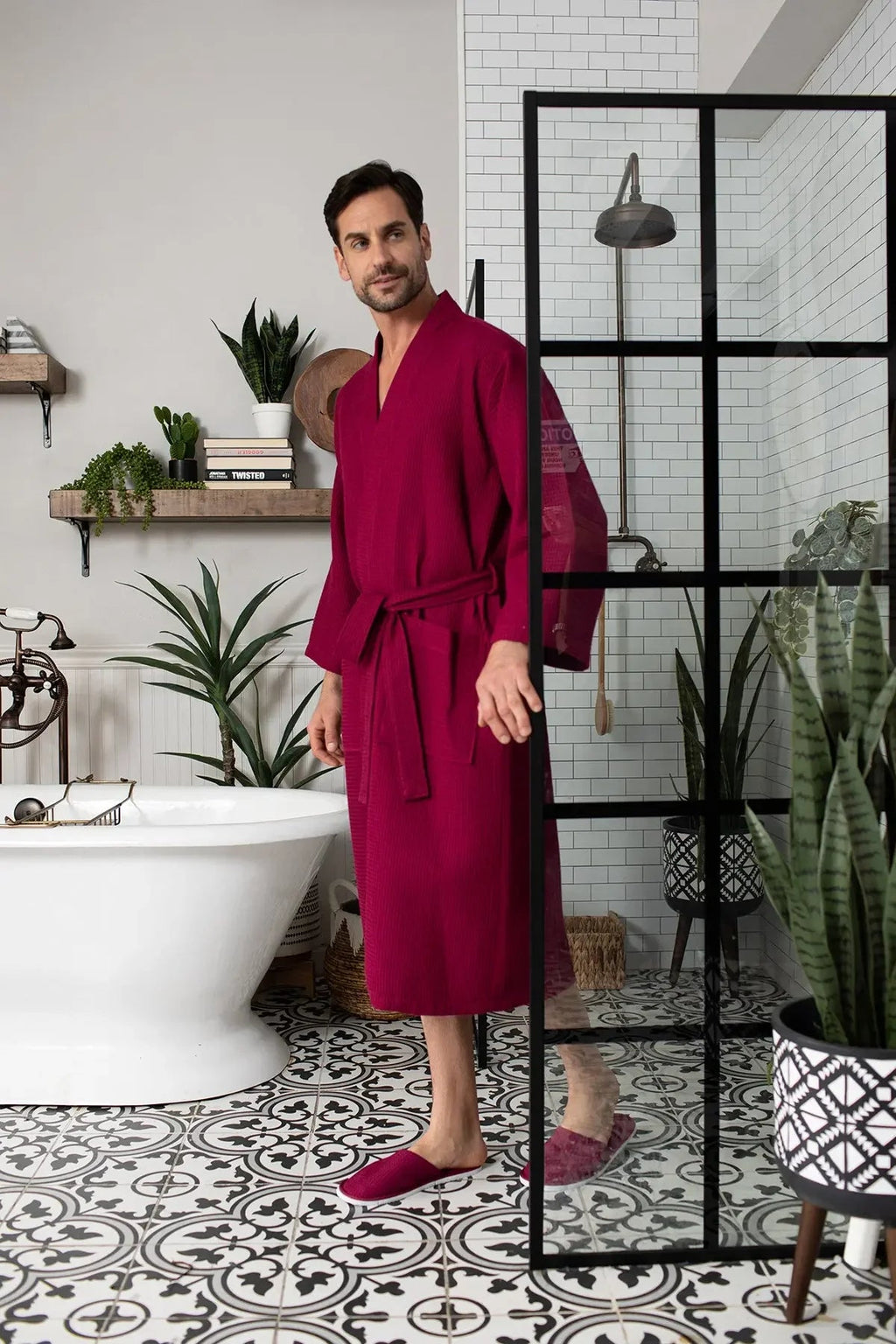 Red waffle spa bathrobe for men from Plush Fashion Hub, lightweight and absorbent, shown hanging on a hook.