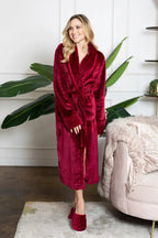 Red plush women's bathrobe from Plush Fashion Hub, showcasing its soft, cozy fabric and relaxed fit.
