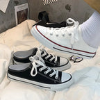Women's round toe lace-up canvas sneakers by Trendsi, featuring a lightweight casual flat design with comfortable all-day wear.