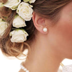 Sterling silver freshwater pearl ear studs with needle backs, elegant jewelry accessory for women.