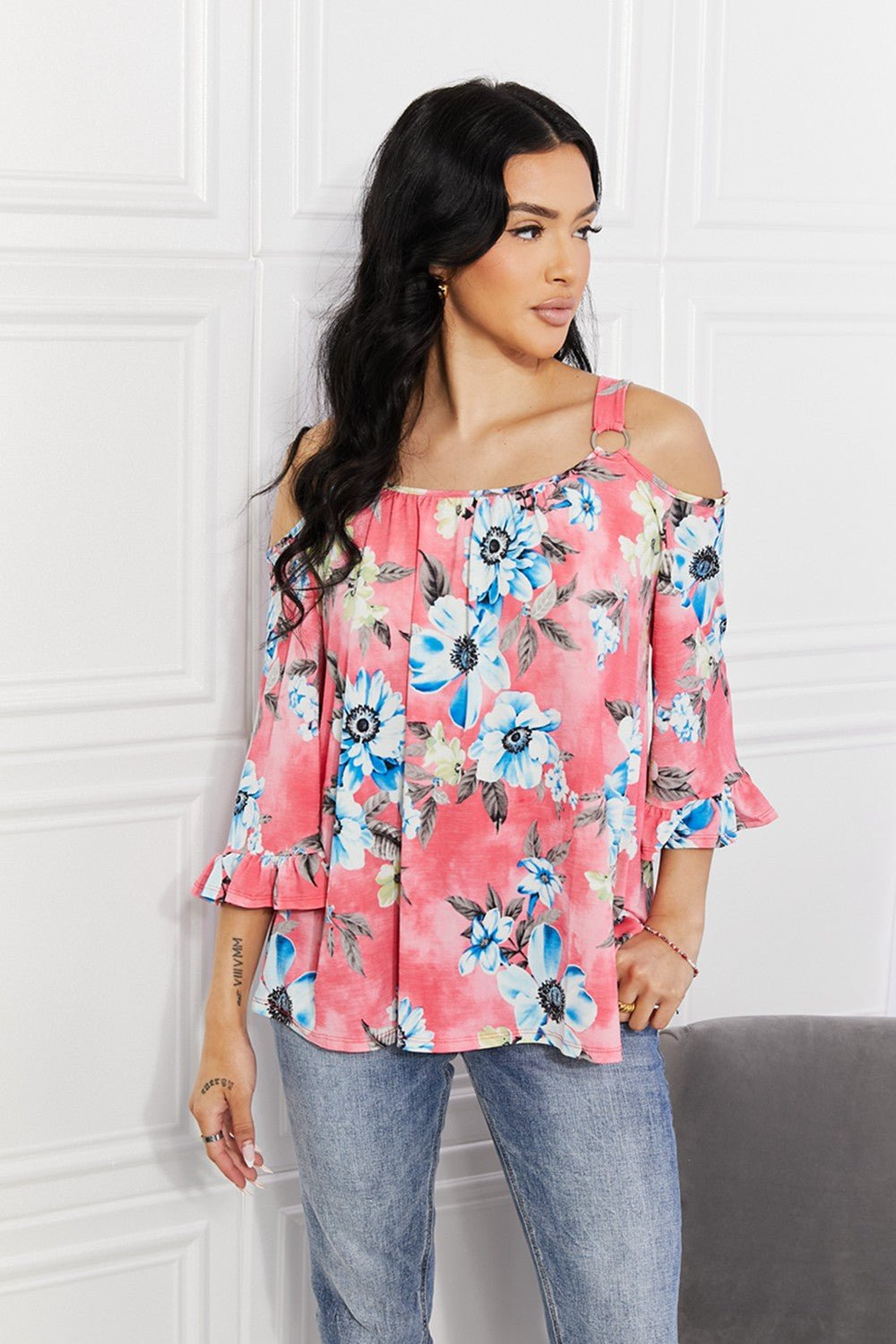 Women’s floral cold-shoulder top with three-quarter sleeves and metal ring details, stylish trendy blouse for women.