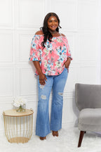 Women’s floral cold-shoulder top with three-quarter sleeves and metal ring details, stylish Trendsi apparel.