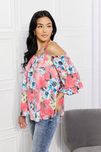Floral cold-shoulder women’s top with three-quarter sleeves and metal ring details, stylish Trendsi women’s apparel.