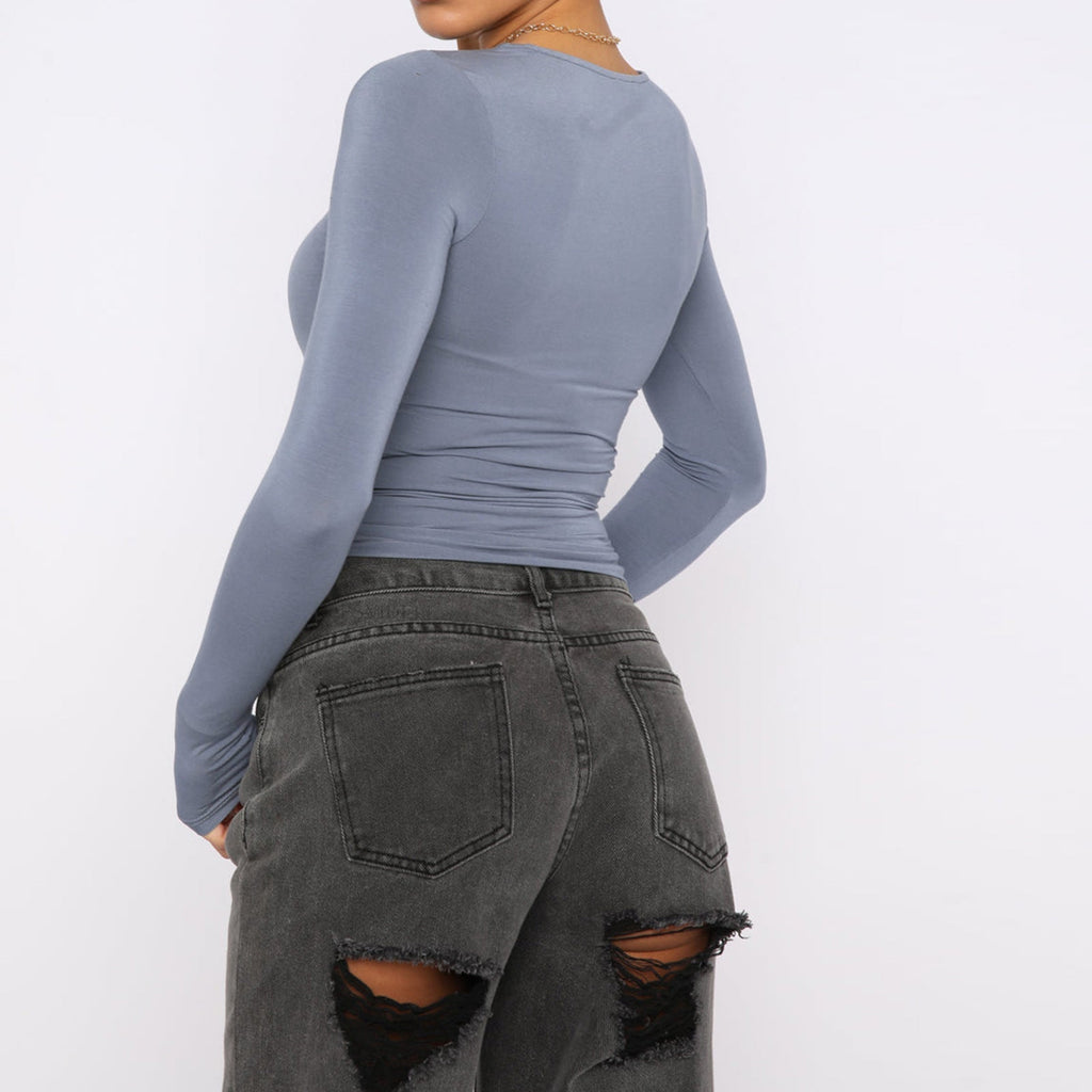 Slim fit women's long sleeve casual crop top by Plush Fashion Hub, shown in a relaxed, stylish fit on a model.